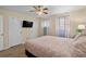 Bedroom featuring a king bed, ceiling fan, two windows, and white doors at 707 S 26Th Ave. S # L, North Myrtle Beach, SC 29582