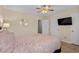 Bedroom with king bed, ceiling fan, wood floors, and a mounted TV at 707 S 26Th Ave. S # L, North Myrtle Beach, SC 29582