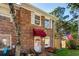 Charming brick townhome featuring an American flag, inviting entrance with a red awning and decorated door at 707 S 26Th Ave. S # L, North Myrtle Beach, SC 29582