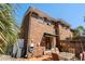Brick home featuring a back patio with outdoor seating, an awning, and an air conditioning unit at 707 S 26Th Ave. S # L, North Myrtle Beach, SC 29582
