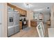 Well-lit kitchen with granite countertops, stainless steel appliances, and wood cabinetry at 707 S 26Th Ave. S # L, North Myrtle Beach, SC 29582