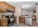 Kitchen featuring stainless steel appliances, a breakfast bar, and wood cabinets at 707 S 26Th Ave. S # L, North Myrtle Beach, SC 29582