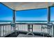 Balcony features a table and seating, providing a stunning view of the beach and ocean at 720 N Waccamaw Dr. # 207, Garden City Beach, SC 29576