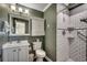Neat bathroom features a white vanity, toilet, medicine cabinet, and a walk-in shower at 720 N Waccamaw Dr. # 207, Garden City Beach, SC 29576