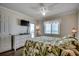 Bright bedroom with a flat-screen TV, a white dresser, and access to a balcony overlooking the ocean at 720 N Waccamaw Dr. # 207, Garden City Beach, SC 29576