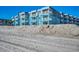 Condo building with multiple units, each having a private balcony overlooking the beach at 720 N Waccamaw Dr. # 207, Garden City Beach, SC 29576
