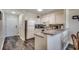 This well-lit kitchen features white cabinetry, granite countertops, and modern appliances at 720 N Waccamaw Dr. # 207, Garden City Beach, SC 29576