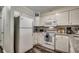 This well-lit kitchen features white cabinetry, granite countertops, and stainless appliances at 720 N Waccamaw Dr. # 207, Garden City Beach, SC 29576