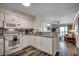 Cozy kitchen flows into the living area with granite countertops, wooden floors, and a view of the ocean at 720 N Waccamaw Dr. # 207, Garden City Beach, SC 29576
