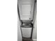 Convenient, stacked, Whirlpool washer and dryer for space-saving laundry at 720 N Waccamaw Dr. # 207, Garden City Beach, SC 29576