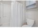 Bathroom features toilet, shower with white curtain, grab bar, and built-in shelves at 775 Plantation Dr. # 87, Little River, SC 29566