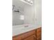 Bathroom with white countertop, wood vanity and large mirror over sink at 775 Plantation Dr. # 87, Little River, SC 29566