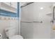 Bathroom with white toilet, shower with clear sliding door, and grab bars at 775 Plantation Dr. # 87, Little River, SC 29566