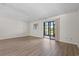 Empty bedroom with wood-look flooring, window, and sliding door to the back at 775 Plantation Dr. # 87, Little River, SC 29566