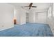 Bedroom showing blue carpet, ceiling fan and en suite bathroom with wood vanity at 775 Plantation Dr. # 87, Little River, SC 29566