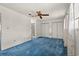 Bright bedroom features blue carpet, ceiling fan, two windows, double closets, and en suite bathroom at 775 Plantation Dr. # 87, Little River, SC 29566