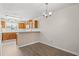 Cozy dining area with a chandelier and wood-look flooring at 775 Plantation Dr. # 87, Little River, SC 29566