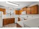 The kitchen showcases white appliances, wood cabinets, and white countertops at 775 Plantation Dr. # 87, Little River, SC 29566