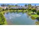 Beautiful pond with a fountain, surrounded by lush greenery and the community townhomes at 775 Plantation Dr. # 87, Little River, SC 29566
