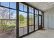 Enclosed porch with black window frames overlooking lake view at 775 Plantation Dr. # 87, Little River, SC 29566