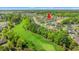 Aerial view of home overlooking green golf course and pond with fountain at 809 Covelo Ln., Myrtle Beach, SC 29579