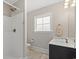 Bright bathroom featuring shower, vanity and frosted window for privacy at 809 Covelo Ln., Myrtle Beach, SC 29579