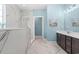 Bright bathroom featuring marble tile shower, dark cabinets, and beach themed art at 809 Covelo Ln., Myrtle Beach, SC 29579