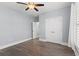 Bright bedroom featuring wood-look floors, ceiling fan and double door closet at 809 Covelo Ln., Myrtle Beach, SC 29579