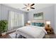 Inviting bedroom with large window, white shutters, ceiling fan and stylish decor at 809 Covelo Ln., Myrtle Beach, SC 29579