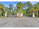 Grand gated entrance to the community with manicured landscaping and mature palm trees at 809 Covelo Ln., Myrtle Beach, SC 29579
