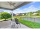 Outdoor patio with chairs overlooking a fenced-in backyard and a serene pond at 809 Covelo Ln., Myrtle Beach, SC 29579