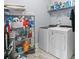 Laundry room with tile floors and white front load washer and dryer at 809 Covelo Ln., Myrtle Beach, SC 29579