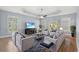 Bright living room with tray ceiling, ceiling fan, light walls and wood floors at 809 Covelo Ln., Myrtle Beach, SC 29579