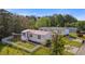 Aerial view of a well-maintained home with a red roof, surrounded by a fenced yard and lush greenery at 8404 Bloomwood Dr., Myrtle Beach, SC 29588