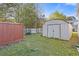 Two storage sheds sit in a large backyard with a fire pit and some woods at 8404 Bloomwood Dr., Myrtle Beach, SC 29588