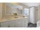 Bright bathroom featuring a double vanity, large mirror, and ample storage at 8404 Bloomwood Dr., Myrtle Beach, SC 29588