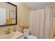 A stylish bathroom features neutral finishes, a patterned shower curtain, and ample lighting at 8404 Bloomwood Dr., Myrtle Beach, SC 29588