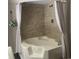 Bathroom showcasing corner bathtub with tiled walls and neutral-colored curtains at 8404 Bloomwood Dr., Myrtle Beach, SC 29588