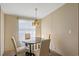 Simple dining area featuring a glass top round table and four chairs at 8404 Bloomwood Dr., Myrtle Beach, SC 29588
