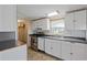 A well-lit kitchen showcasing white cabinets and modern appliances under a bright light fixture at 8404 Bloomwood Dr., Myrtle Beach, SC 29588