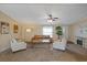 Warm and inviting living room featuring an area rug, comfortable seating, and a ceiling fan at 8404 Bloomwood Dr., Myrtle Beach, SC 29588