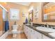 Bathroom featuring double sinks, white cabinets, and nautical decor at 9 Gasparilla Circle, Murrells Inlet, SC 29576