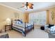 Comfortable bedroom featuring a four-poster bed, a ceiling fan, and plantation shutters at 9 Gasparilla Circle, Murrells Inlet, SC 29576