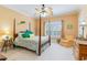 Bright bedroom with tropical-themed decor, colorful bedding, and a wooden four-poster bed at 9 Gasparilla Circle, Murrells Inlet, SC 29576