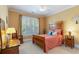 Charming bedroom with a wooden bed frame and sunny window views at 9 Gasparilla Circle, Murrells Inlet, SC 29576