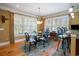 Sun-filled dining room features hardwood flooring, plantation shutters, modern chandelier, and seating for six at 9 Gasparilla Circle, Murrells Inlet, SC 29576