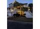 Charming elevated home with three-car garage, accessed by large staircase with palm trees at 9 Gasparilla Circle, Murrells Inlet, SC 29576