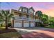 Stunning elevated home boasting a three-car garage, spacious porch, and lush landscaping at 9 Gasparilla Circle, Murrells Inlet, SC 29576