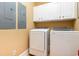 Bright laundry room featuring a modern washer and dryer set, and white cabinets for storage at 9 Gasparilla Circle, Murrells Inlet, SC 29576