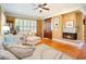 Cozy living room featuring a fireplace, hardwood floors, and comfortable seating at 9 Gasparilla Circle, Murrells Inlet, SC 29576